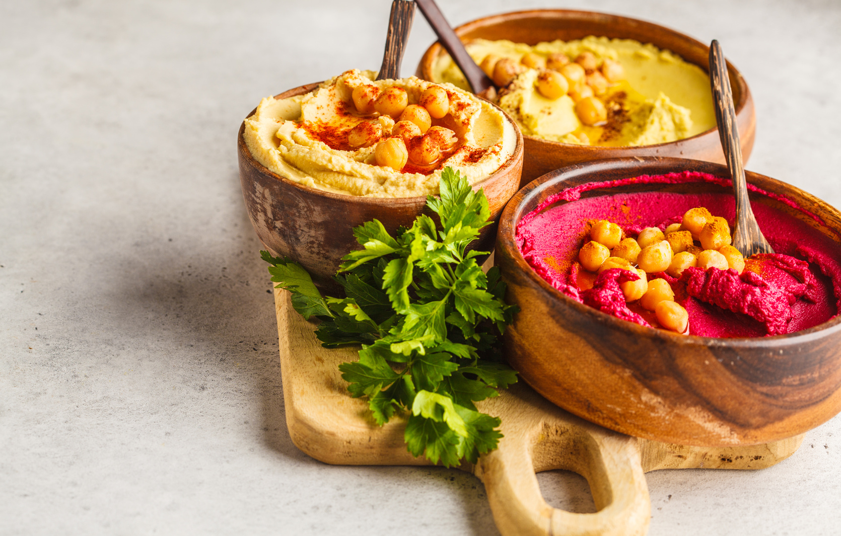 Different Hummus Bowls. Chickpea Hummus, Avocado Hummus and Beet