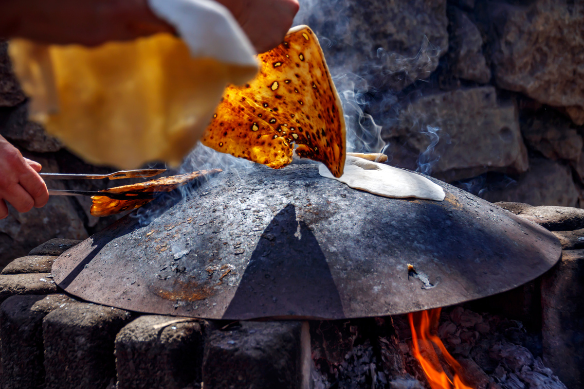 Baking pita breads on a metal plate