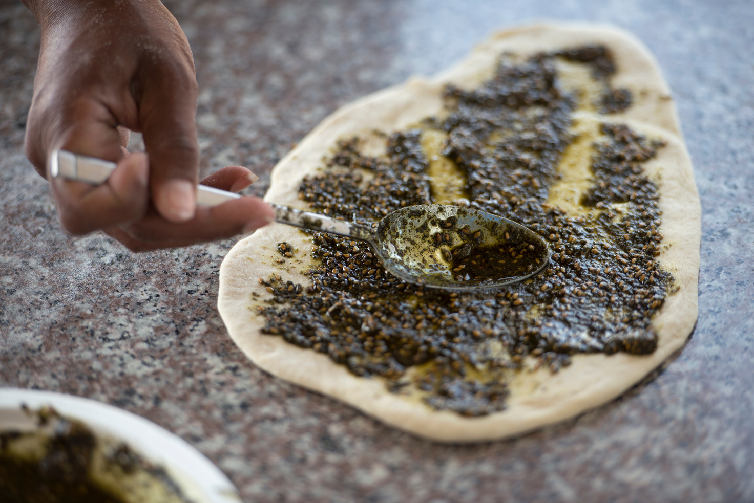 Preparation pita bread with Za'atar spice.