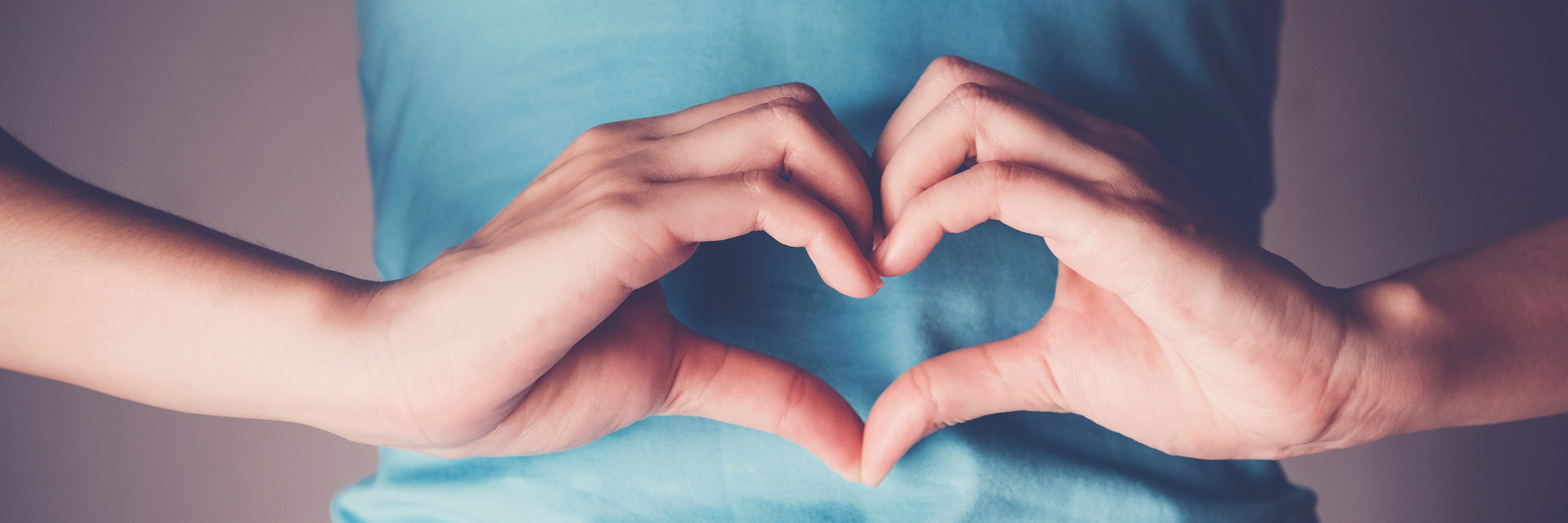 Woman hands making a heart shape on her stomach, healthy bowel digestion, probiotics  for gut health
